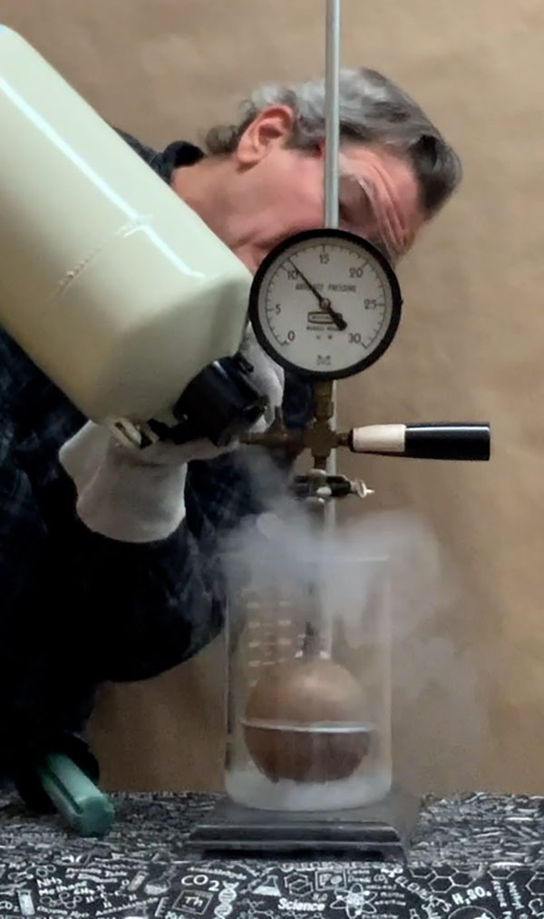 Pressure drops when liquid nitrogen is poured over apparatus.